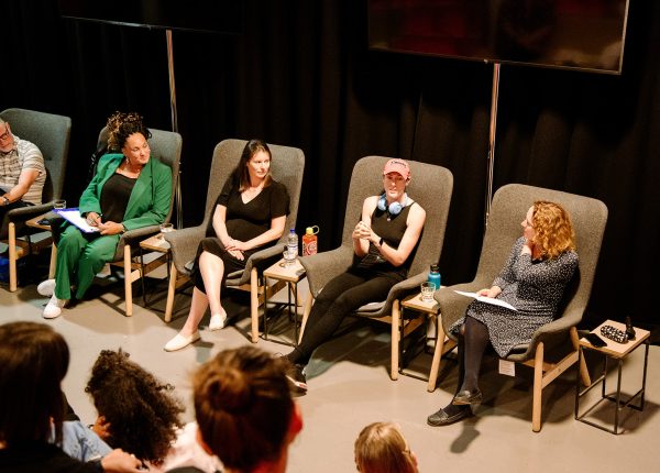 Panel discussion at The Junction in Engine Shed with four speakers engaging audience.