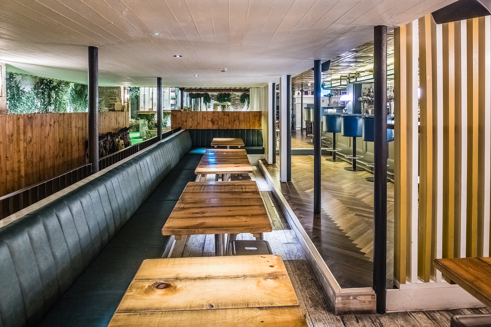 Modern event space with wooden tables, ideal for networking and gatherings.