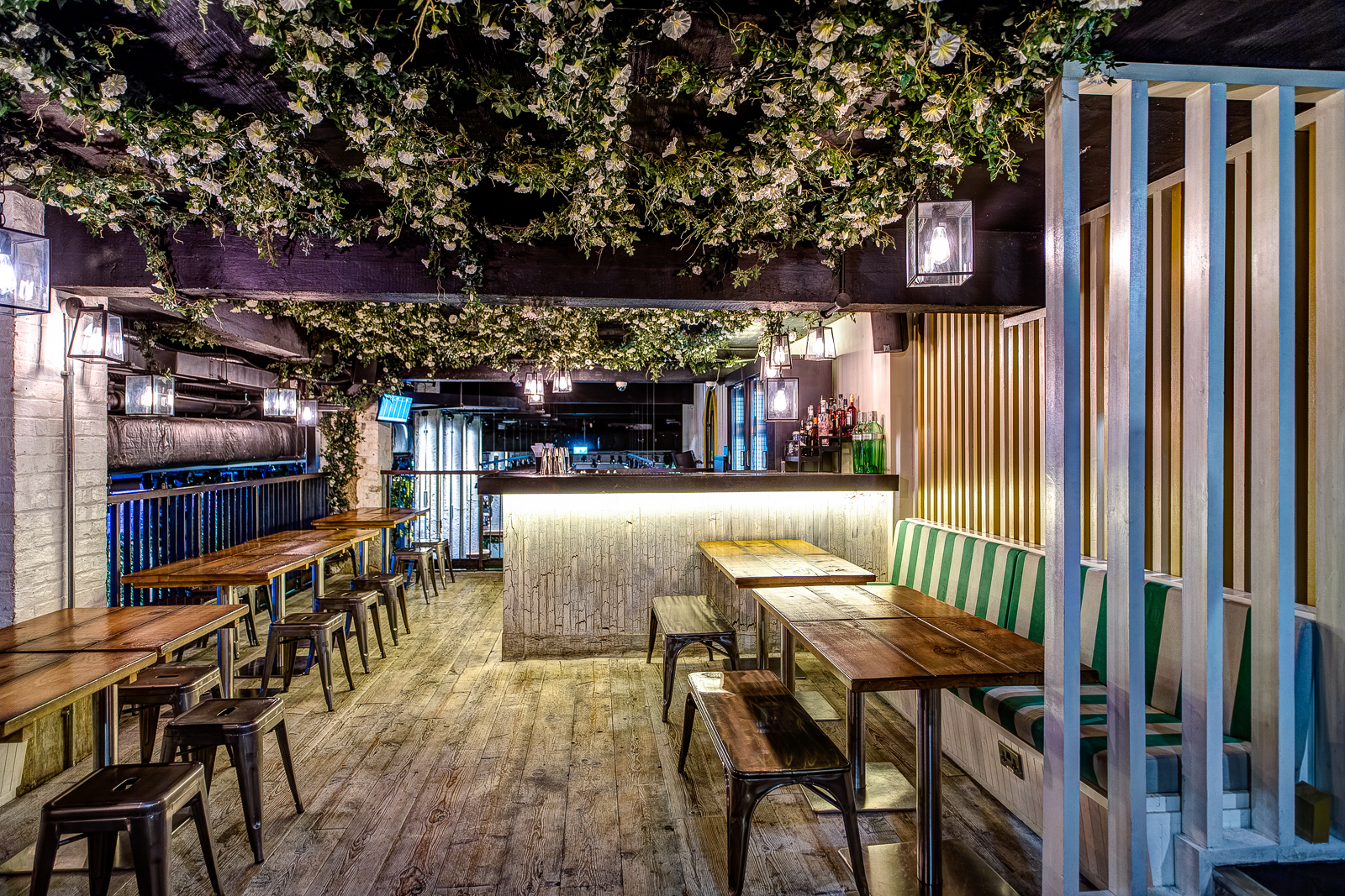 Rustic venue with floral ceiling, perfect for social gatherings and events.