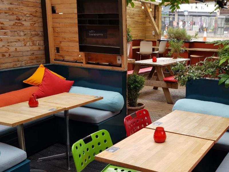 Vibrant pub event space with cozy seating, ideal for networking and gatherings.