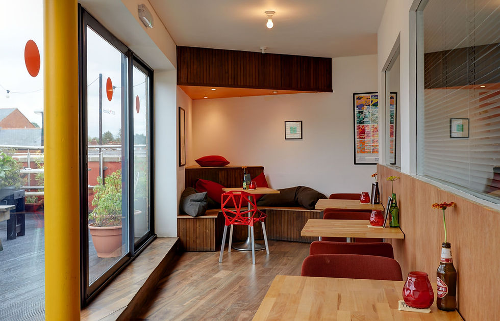 Cozy modern meeting space with natural light for informal gatherings and team meetings.