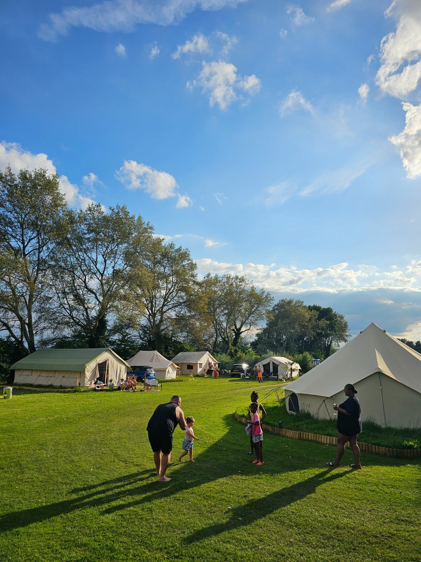 Bell tents in a lush park, perfect for team-building retreats and outdoor gatherings.