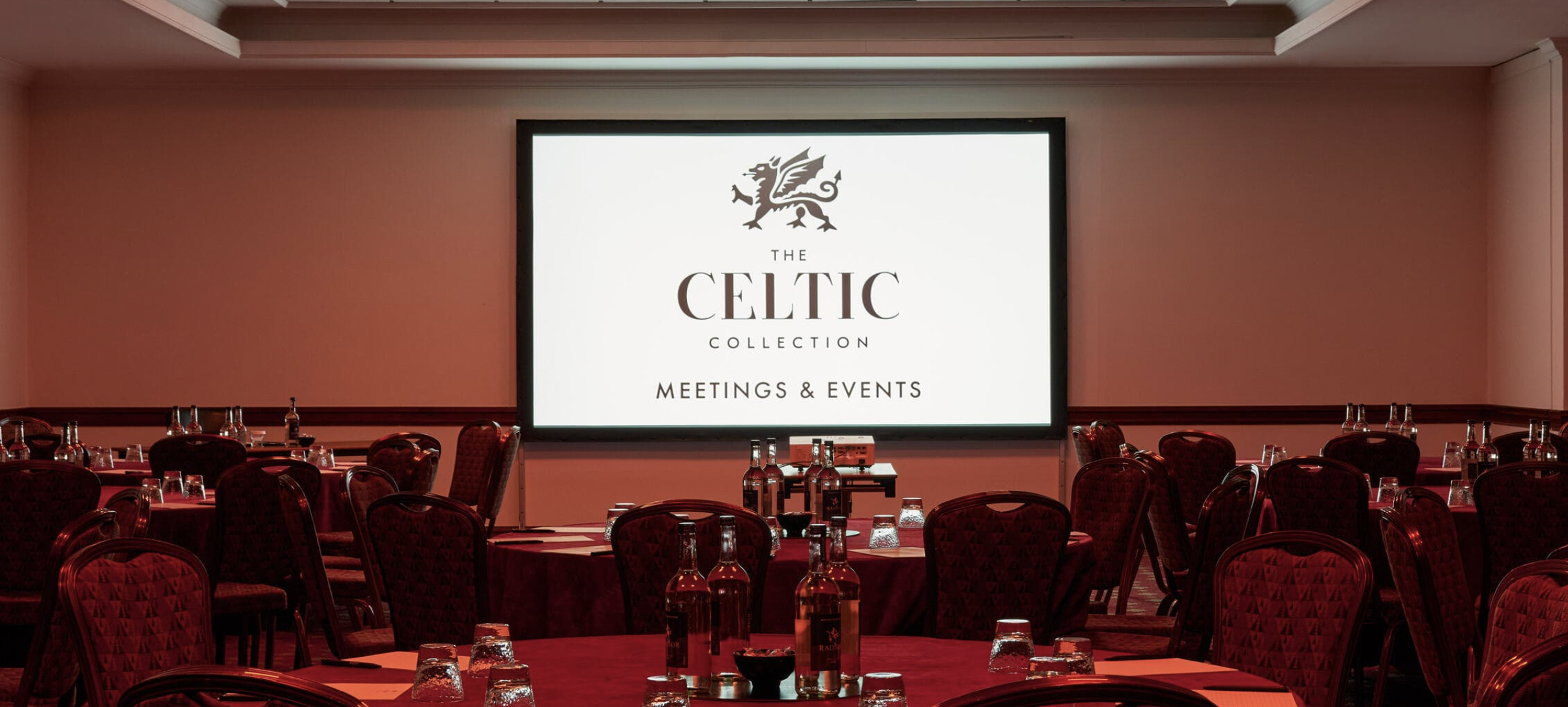 Elegant meeting space with round tables for conferences at Celtic Mannon venue.