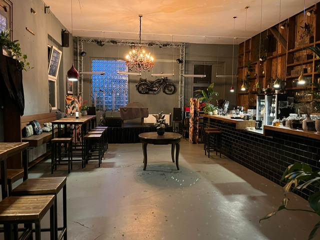 Industrial-chic event space with motorcycle display, perfect for networking and gatherings.