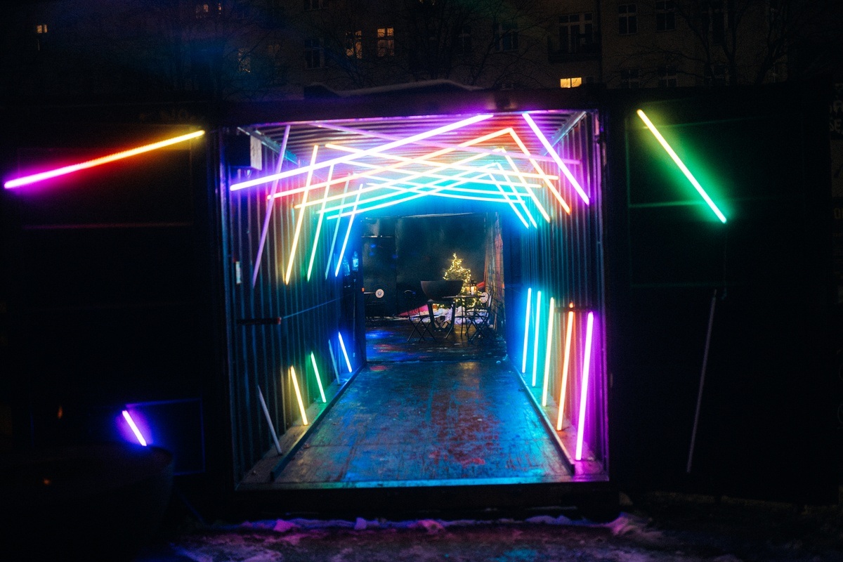 Vibrant TABULA RASA bar entrance with colorful neon lights for themed events.