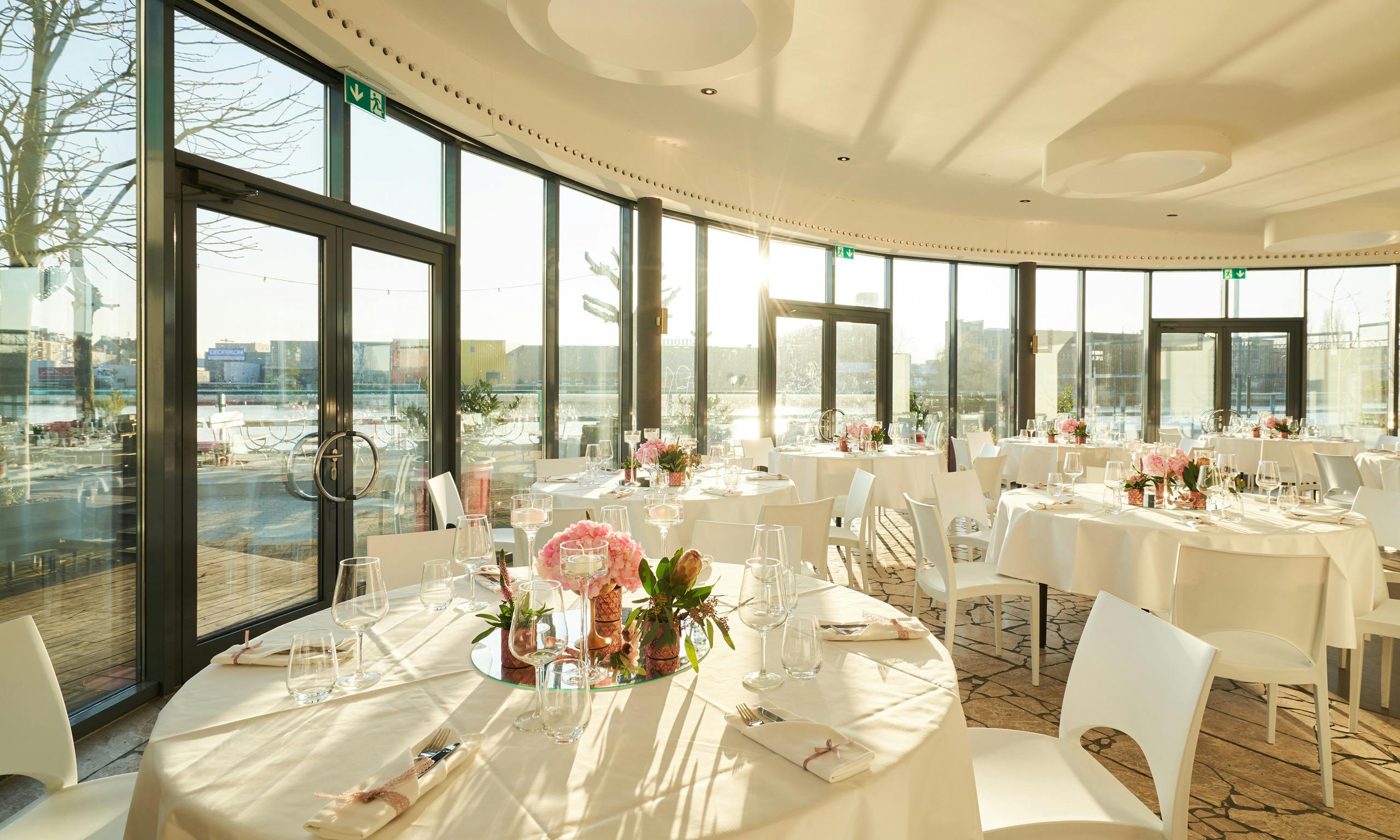 Elegant function room with round tables, perfect for weddings and corporate events.