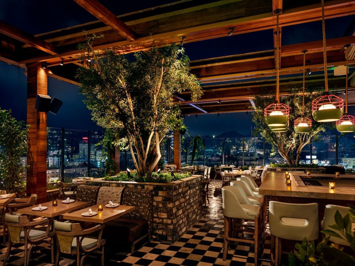 Stylish rooftop lounge with city skyline, perfect for upscale events and gatherings.