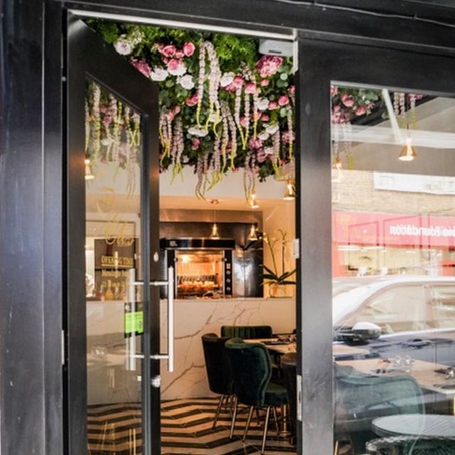 Eli's Restaurant entrance with floral decor, ideal for events and gatherings.