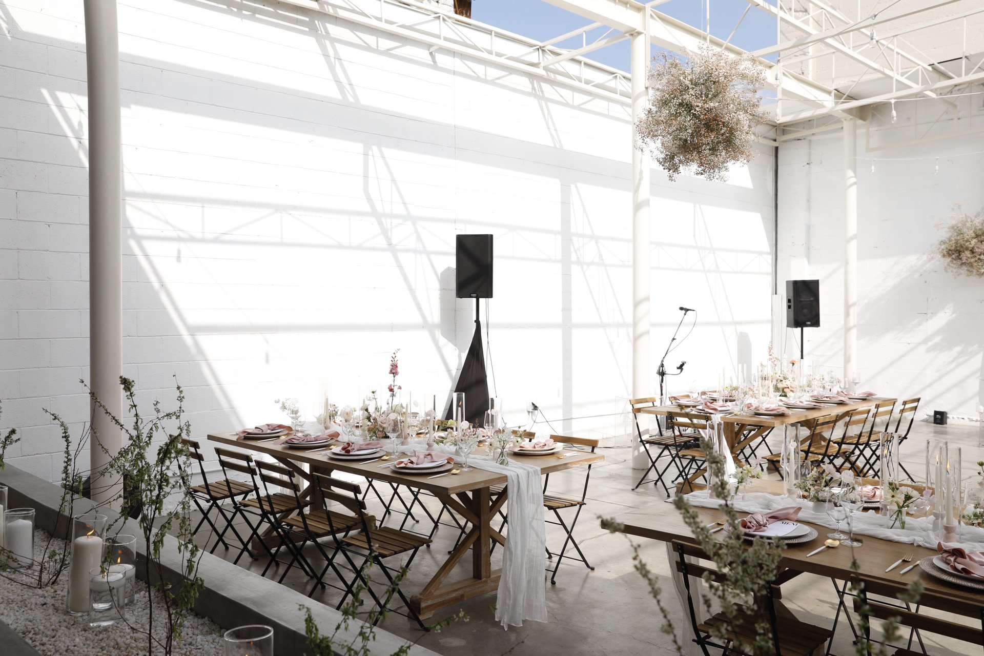 Elegant event venue in The Revery LA with wooden tables, ideal for gatherings and celebrations.