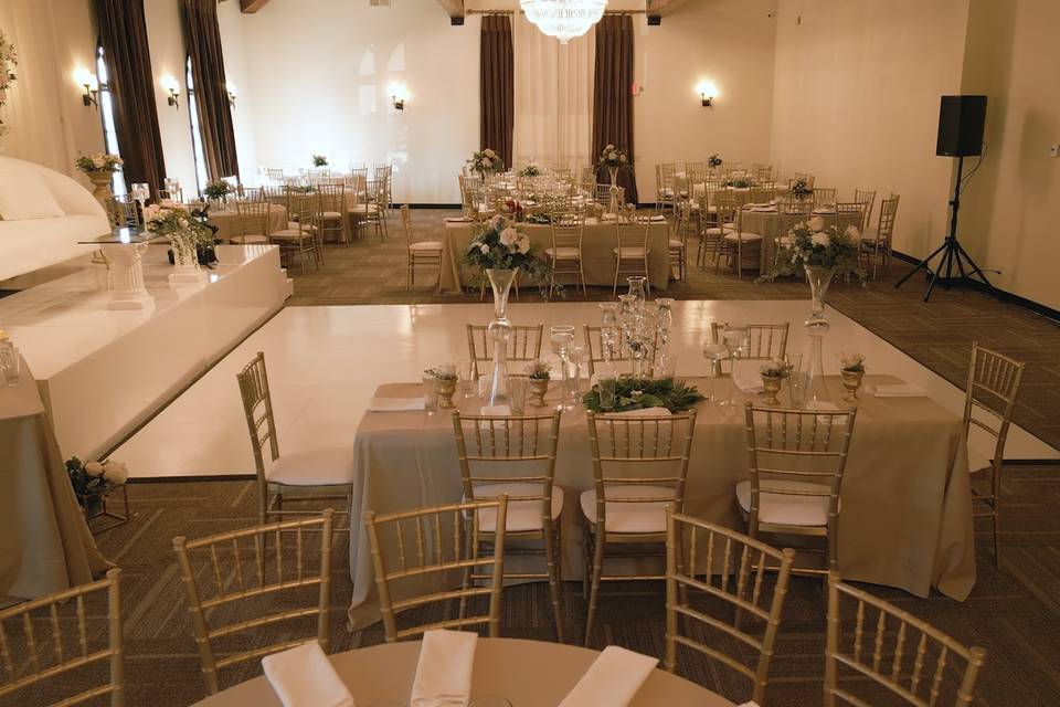 Elegant banquet hall with floral centerpieces, ideal for weddings and formal events.
