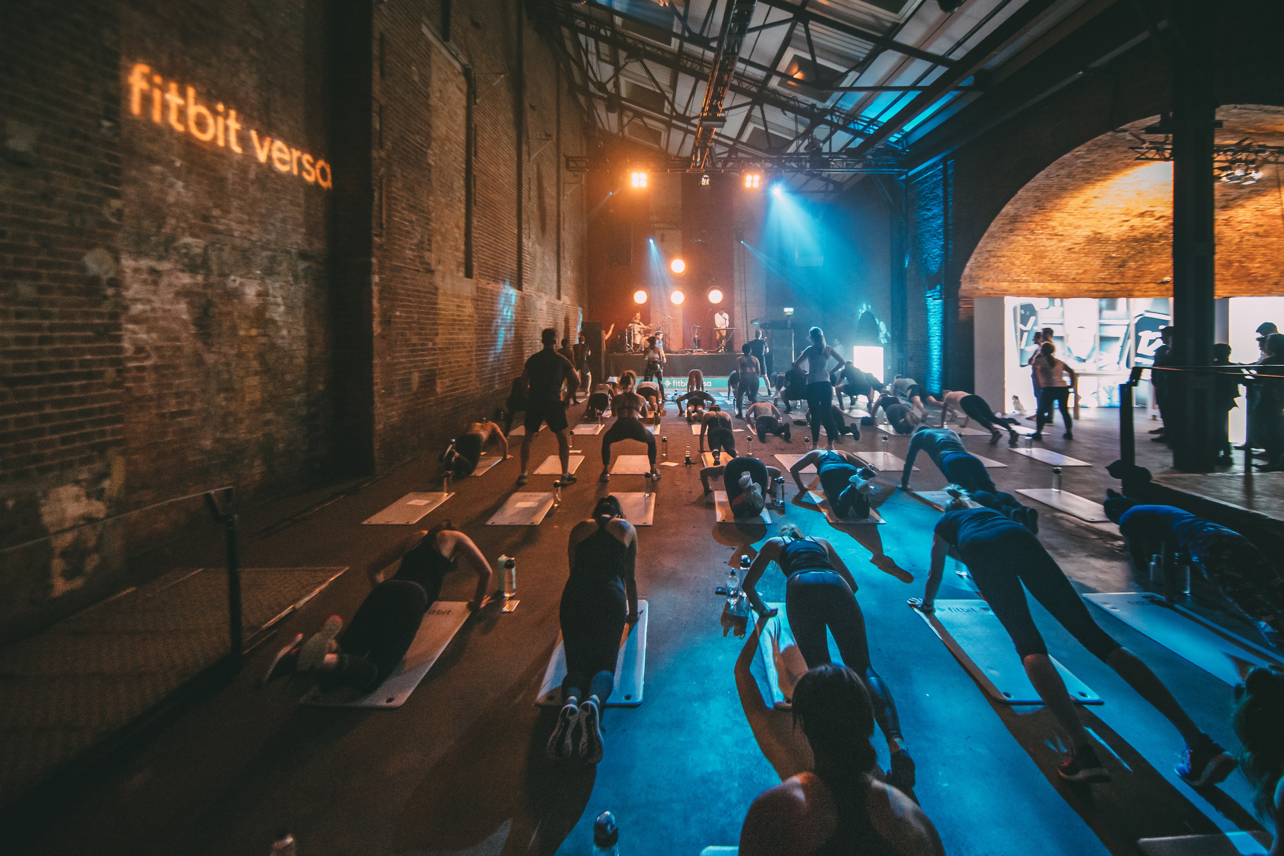 Dynamic fitness event at Village Underground with Fitbit branding, promoting health and wellness.