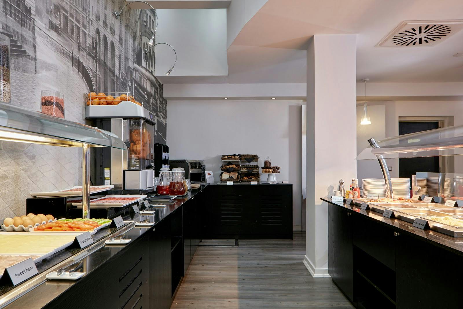 Buffet setup at The Queen's Gate Hotel for meetings and events, featuring diverse food stations.