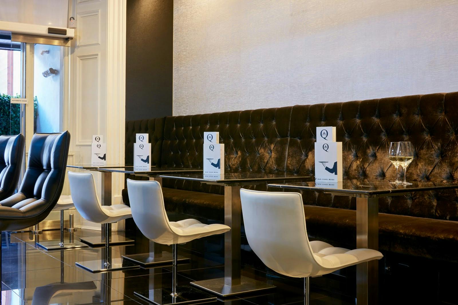 Modern event space at The Queen's Gate Hotel with elegant seating for upscale gatherings.