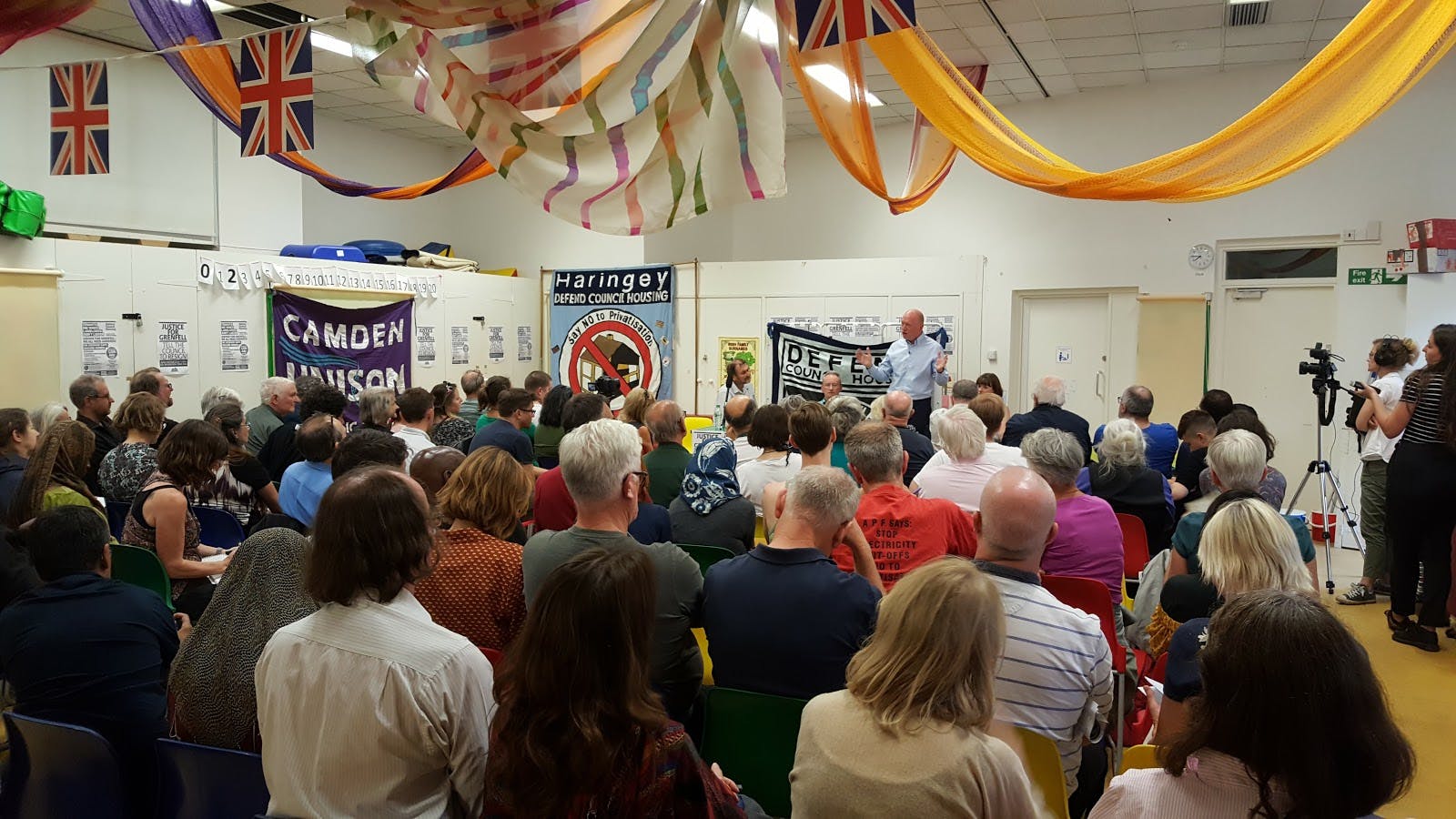 Community center meeting in Somers Town with colorful decorations and engaging layout.