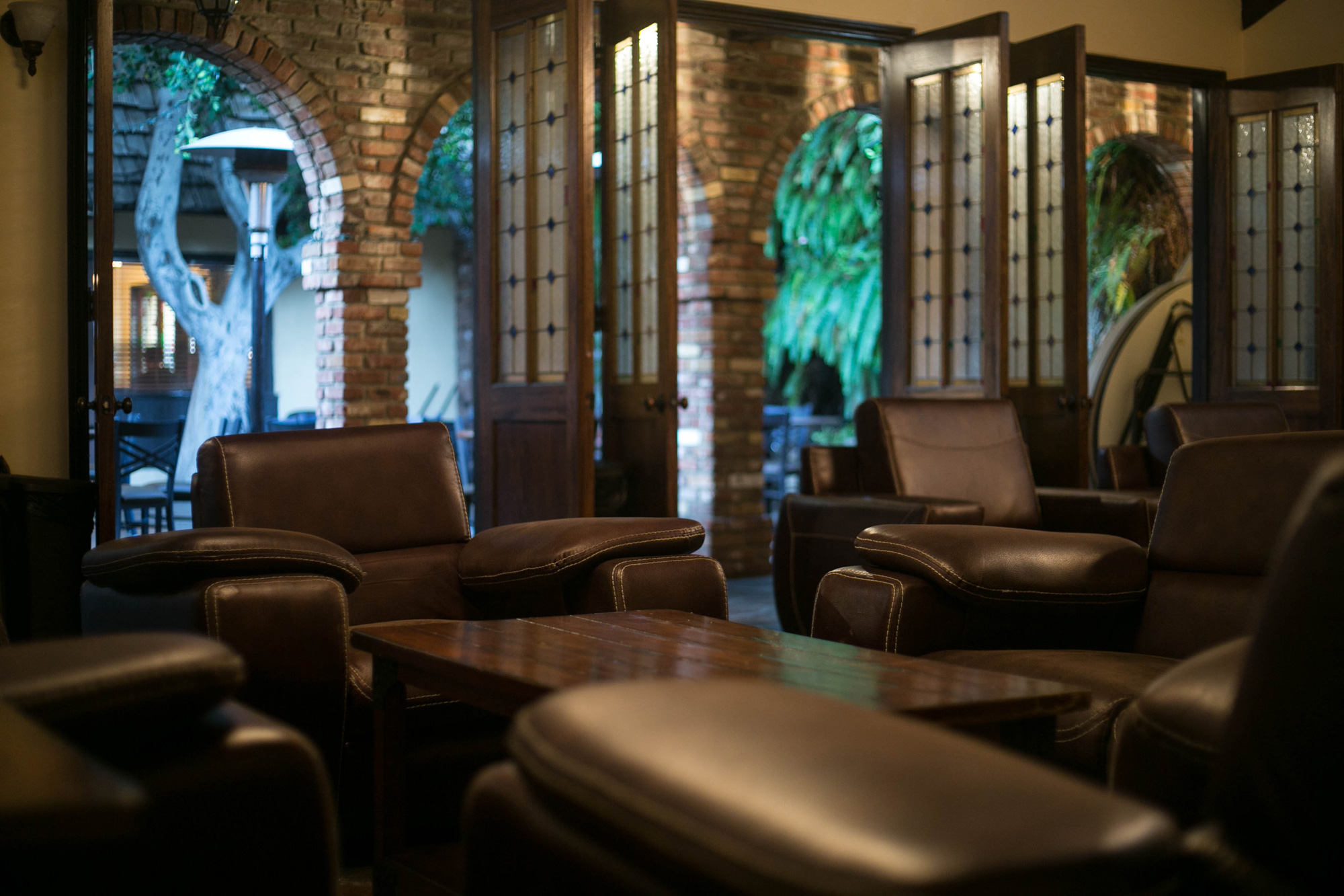 Cozy Vineyard Room lounge with leather seating for networking events and informal meetings.
