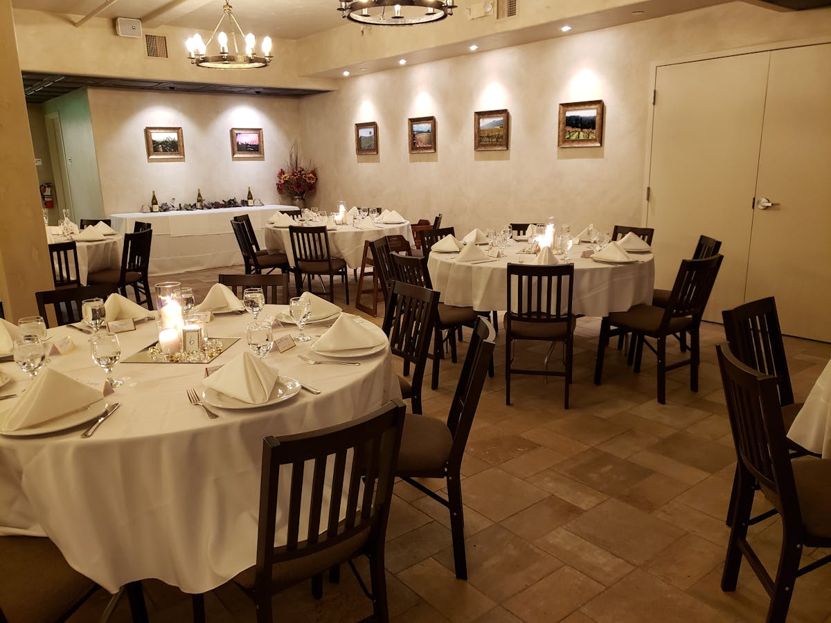 Elegant Vineyard Room dining space with round tables for intimate events and receptions.