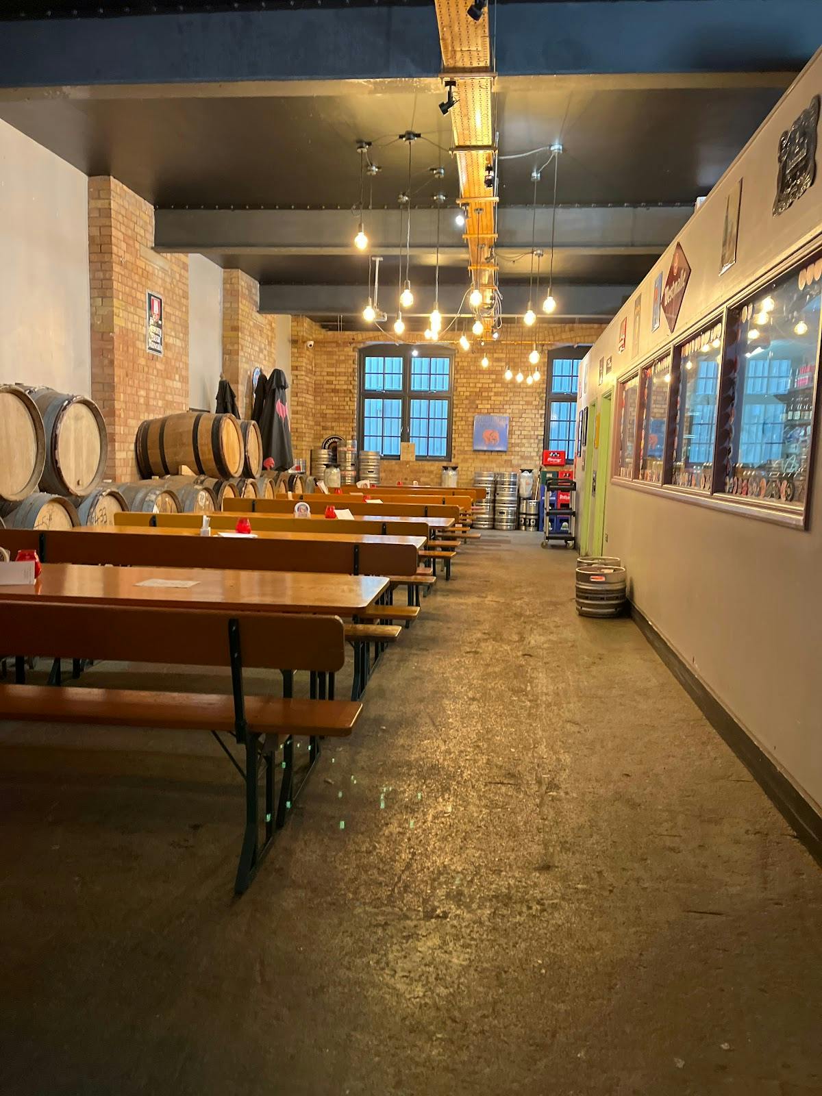 Rustic Taproom with wooden tables, ideal for casual gatherings and corporate events.