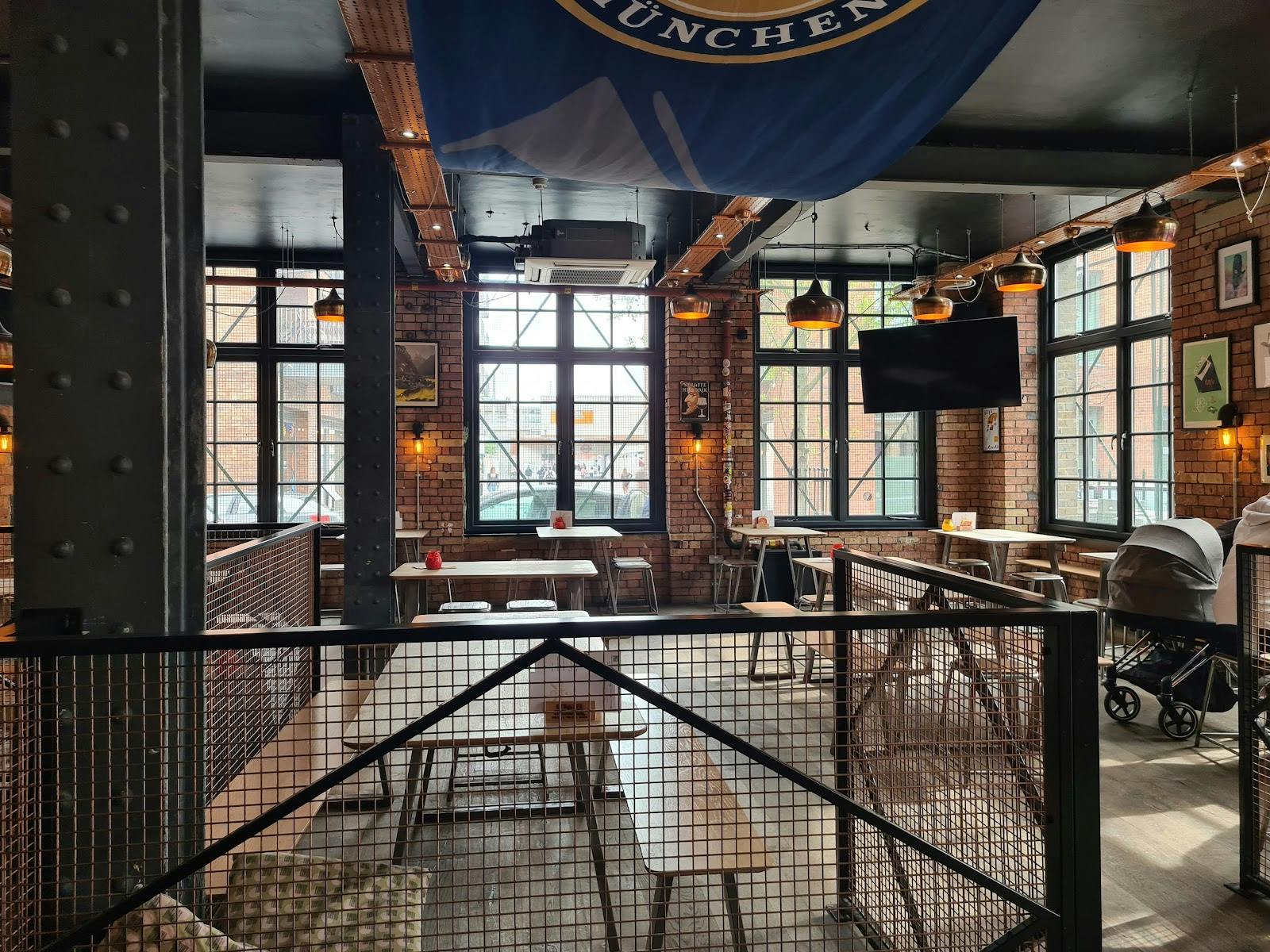 Modern industrial event space with exposed brick, ideal for networking and workshops.