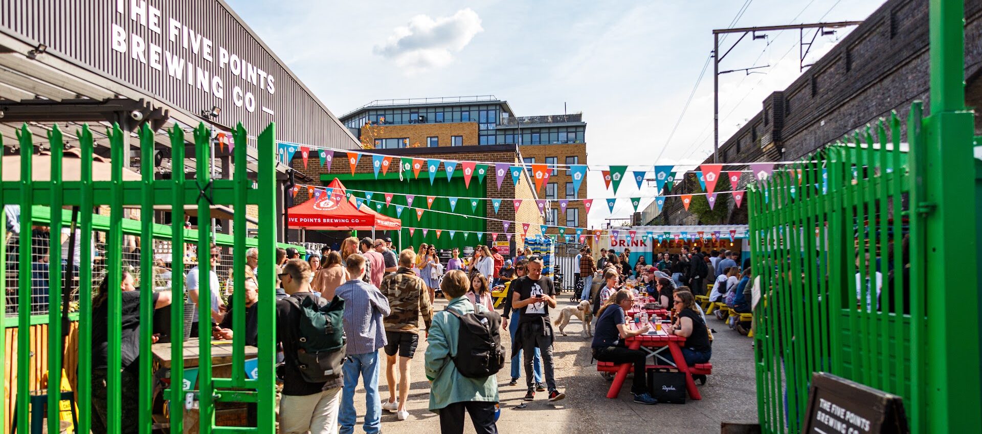 Vibrant outdoor event space at Five Points Taproom with colorful bunting for gatherings.