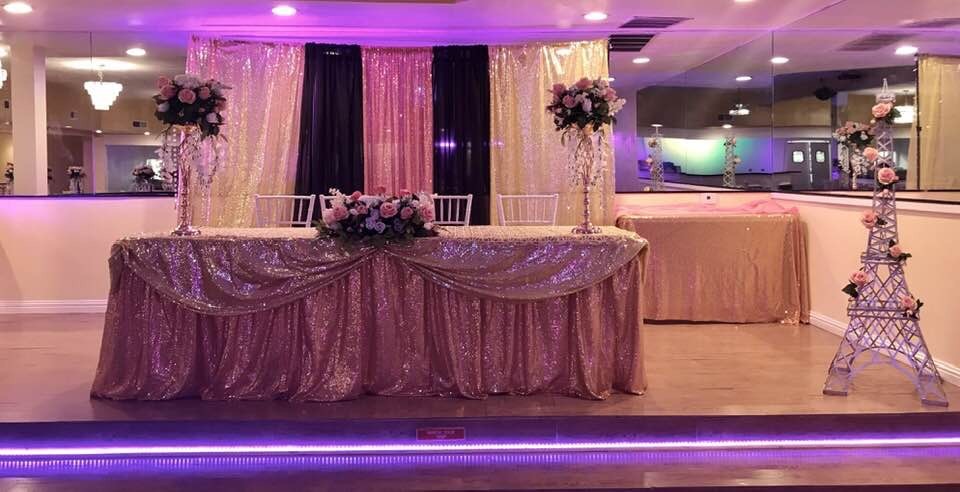 Elegant banquet hall with sequined head table, perfect for weddings and formal events.