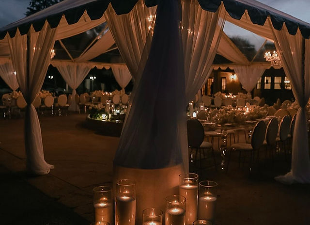 Outdoor event space with elegant drapery, perfect for weddings and upscale gatherings.