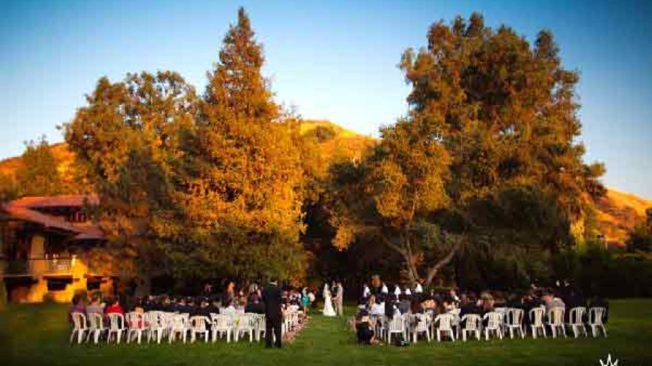 Outdoor wedding ceremony at Brandview Garden with white chairs and lush greenery.