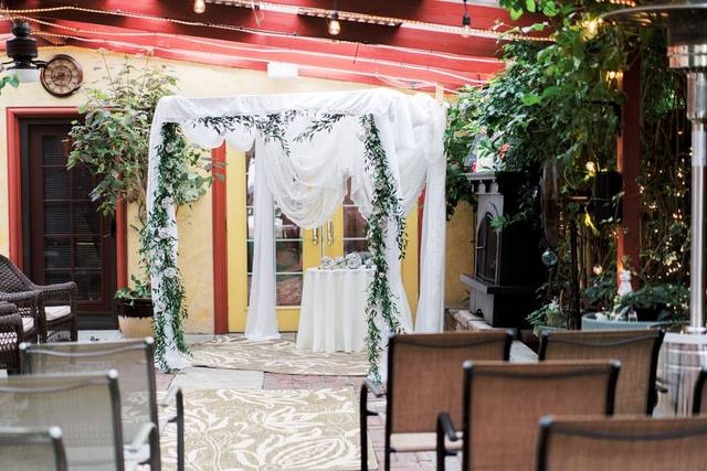 Bar/lounge area with elegant draped arch, perfect for intimate gatherings and ceremonies.