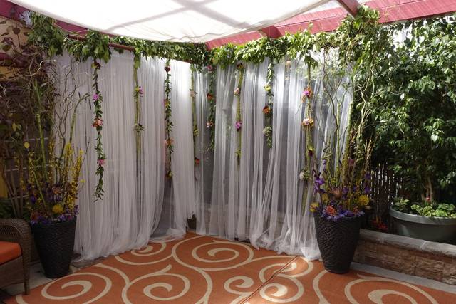 Elegant event space with sheer drapery and floral accents for weddings in Bexx Secret Garden.