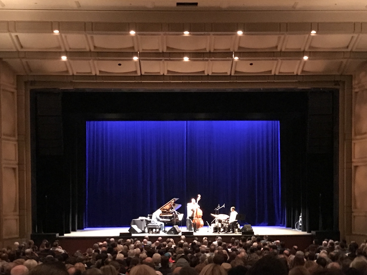 Royce Hall stage with blue curtain during a live music performance event.