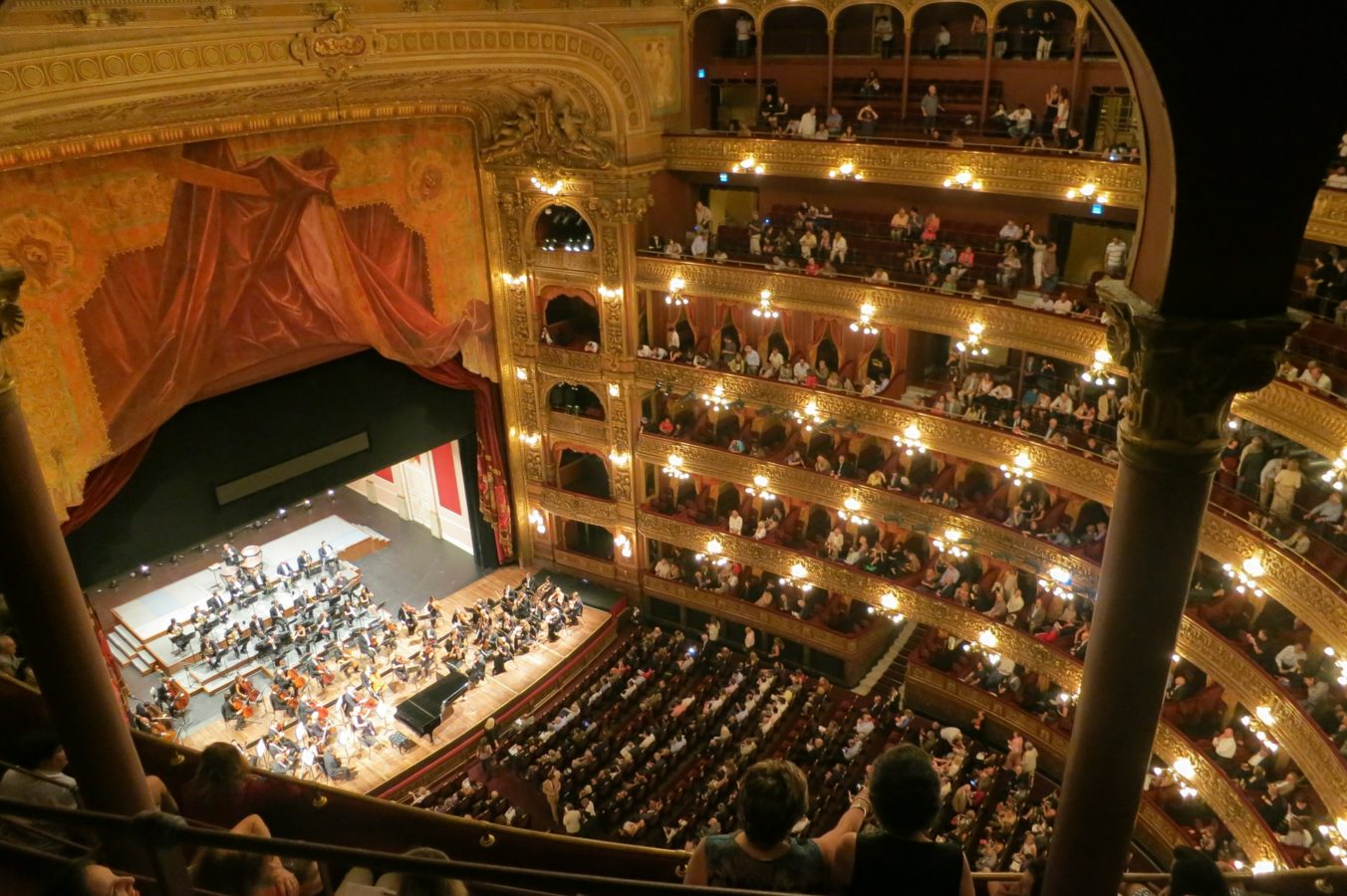 Ornate Royce Hall stage with orchestra, ideal for cultural events and performances.
