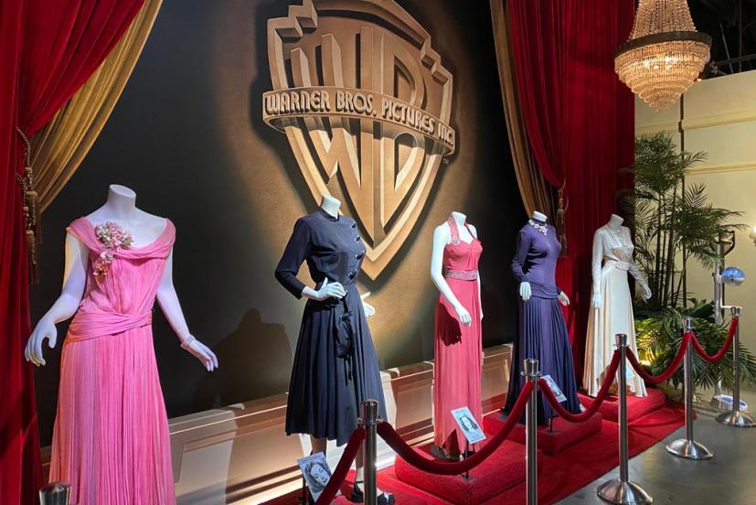 Elegant dresses on display in Warner Bros. Studios' Terrace Room for gala events.