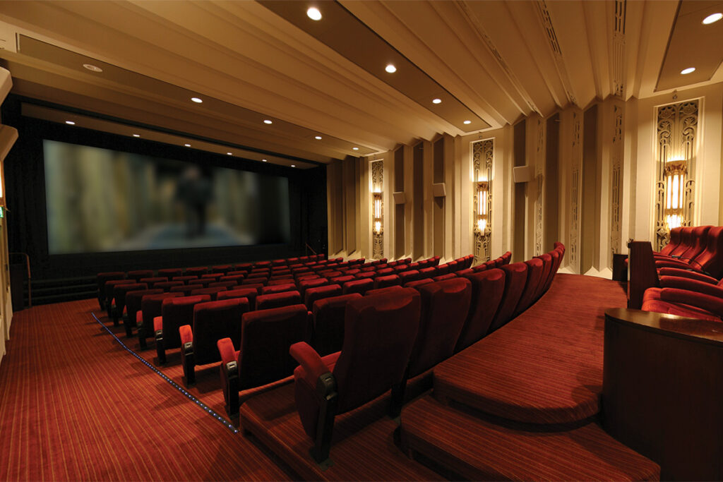 Terrace Room at Warner Bros. Studios with plush red seating for film screenings and events.