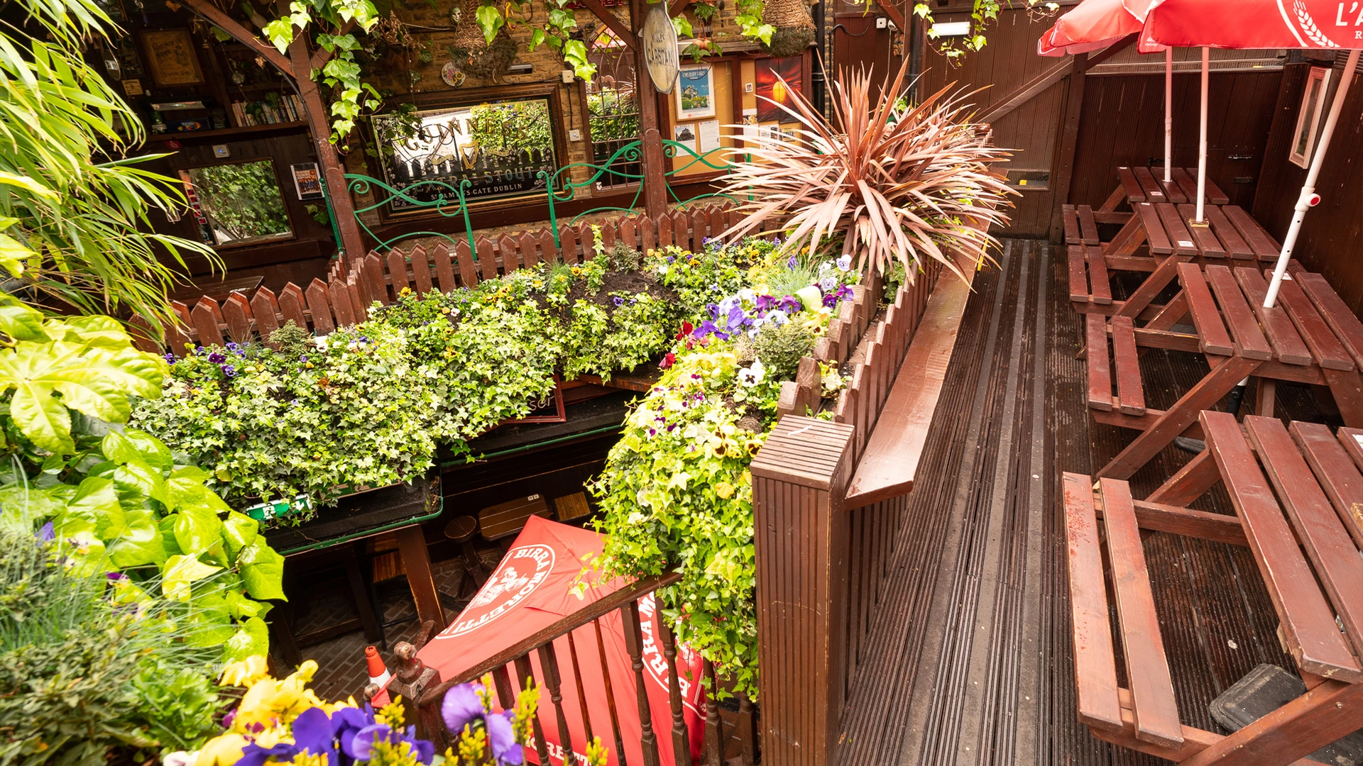 Charming outdoor venue with lush greenery for casual gatherings and networking events.