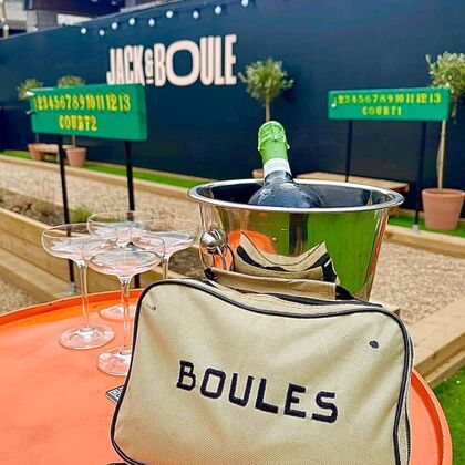 Stylish outdoor event setup with champagne bucket and glassware for networking gatherings.