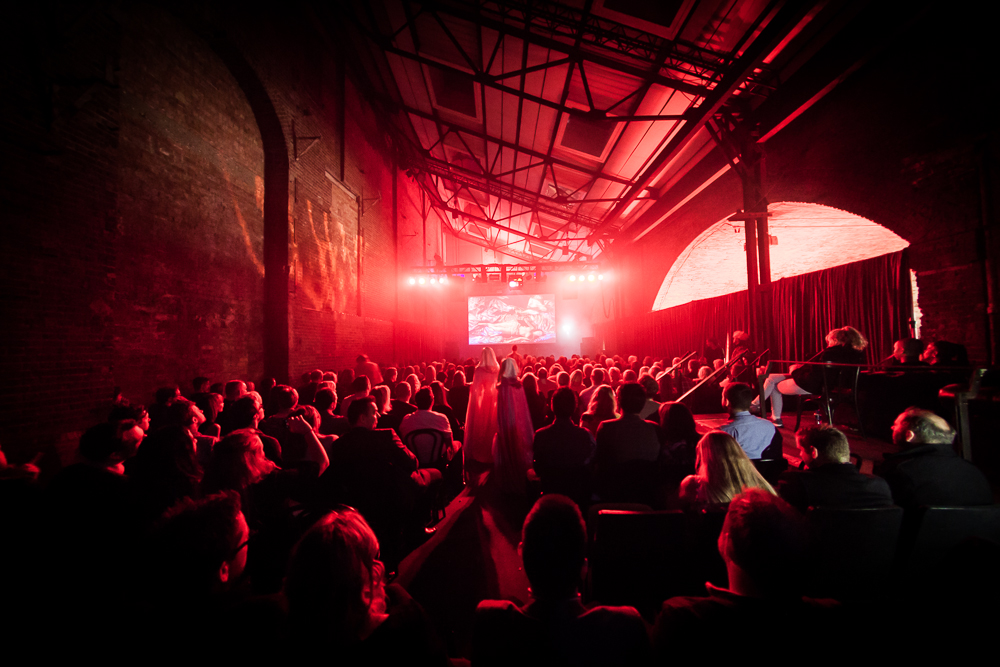 Dynamic event space at Village Underground with red lighting for immersive presentations.