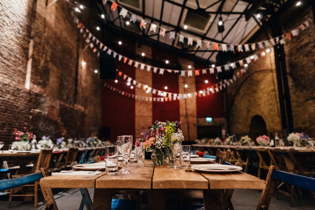 Event space at Village Underground with floral centerpieces, ideal for gatherings and celebrations.