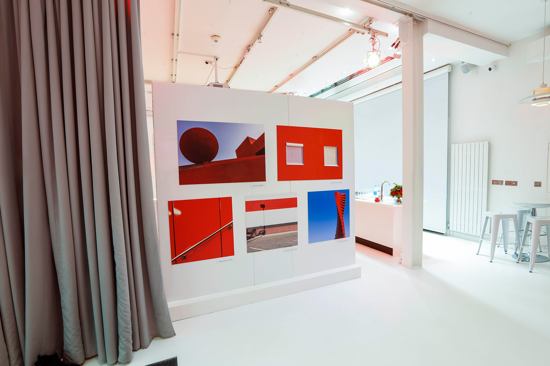 Modern event space with vibrant red artwork, ideal for creative meetings and networking.