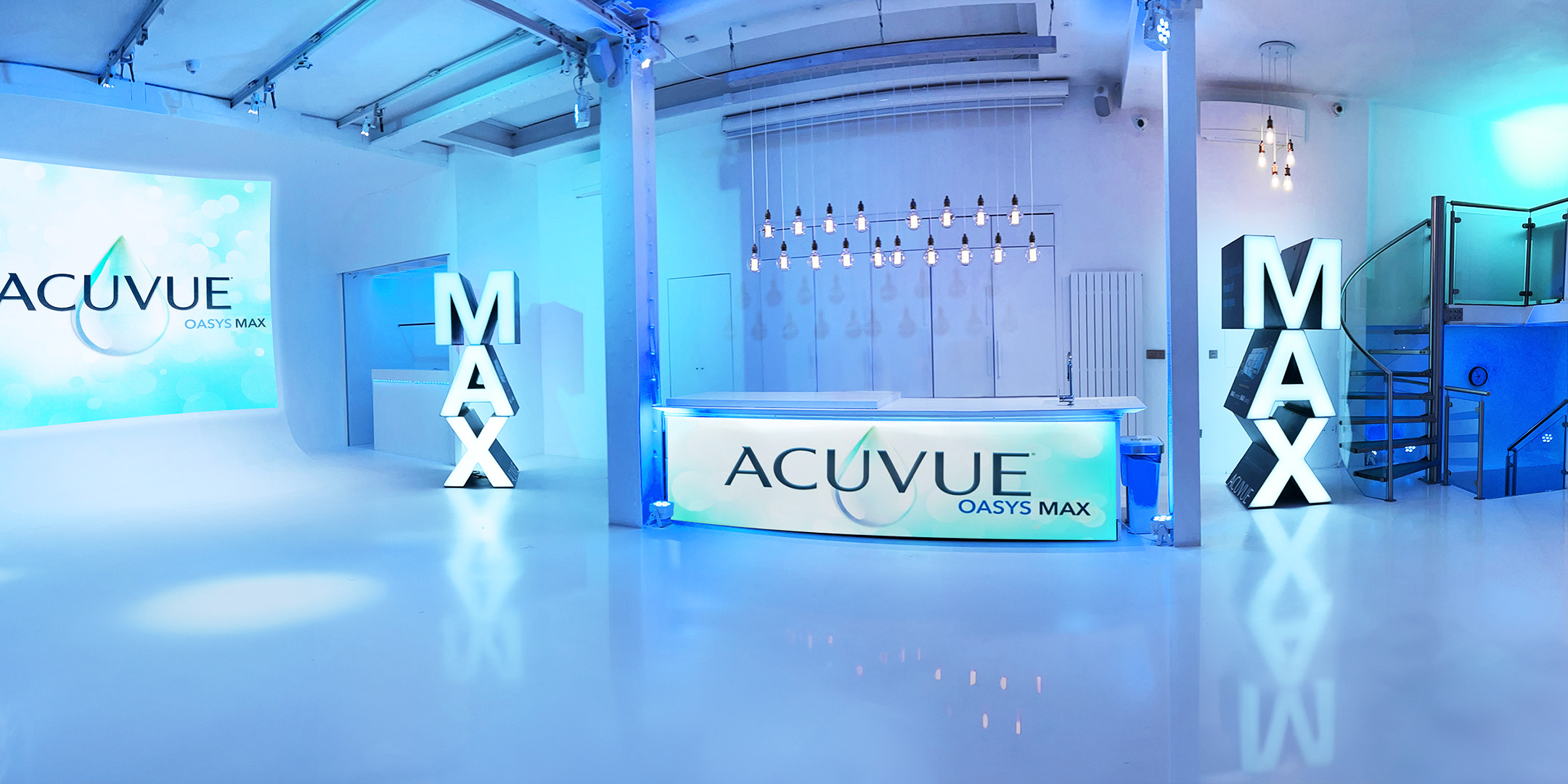 Modern event space for ACUVUE product launch with blue lighting and branding.