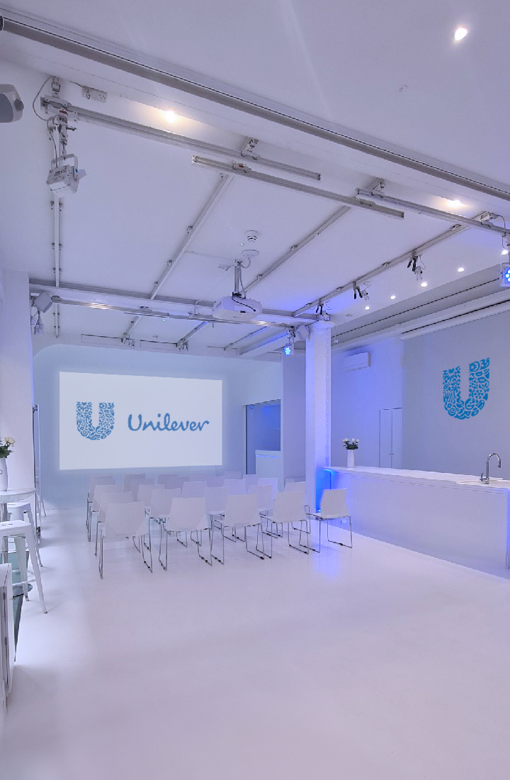 Modern corporate event space with Unilever logo, ideal for meetings and workshops.