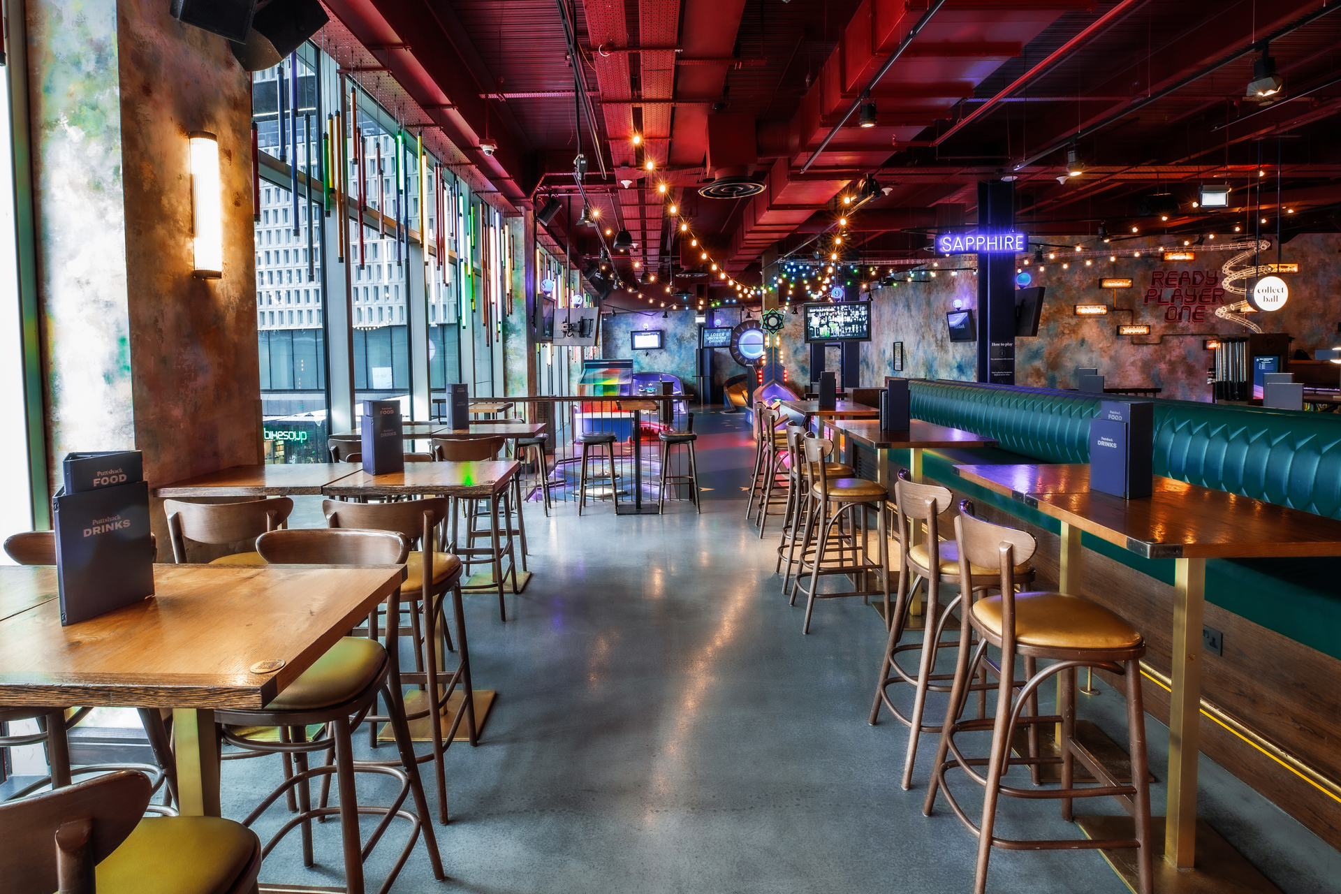 Vibrant Christmas event space with modern decor at Puttshack White City, ideal for gatherings.