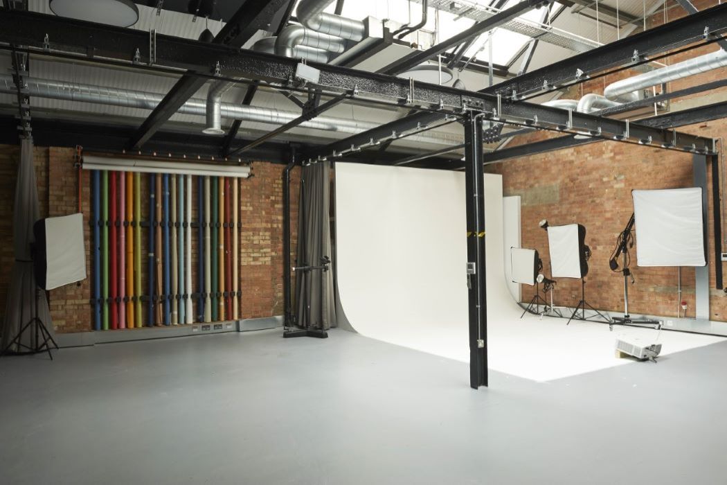 Infinity Cove event space with vibrant striped wall, ideal for creative meetings and photo shoots.