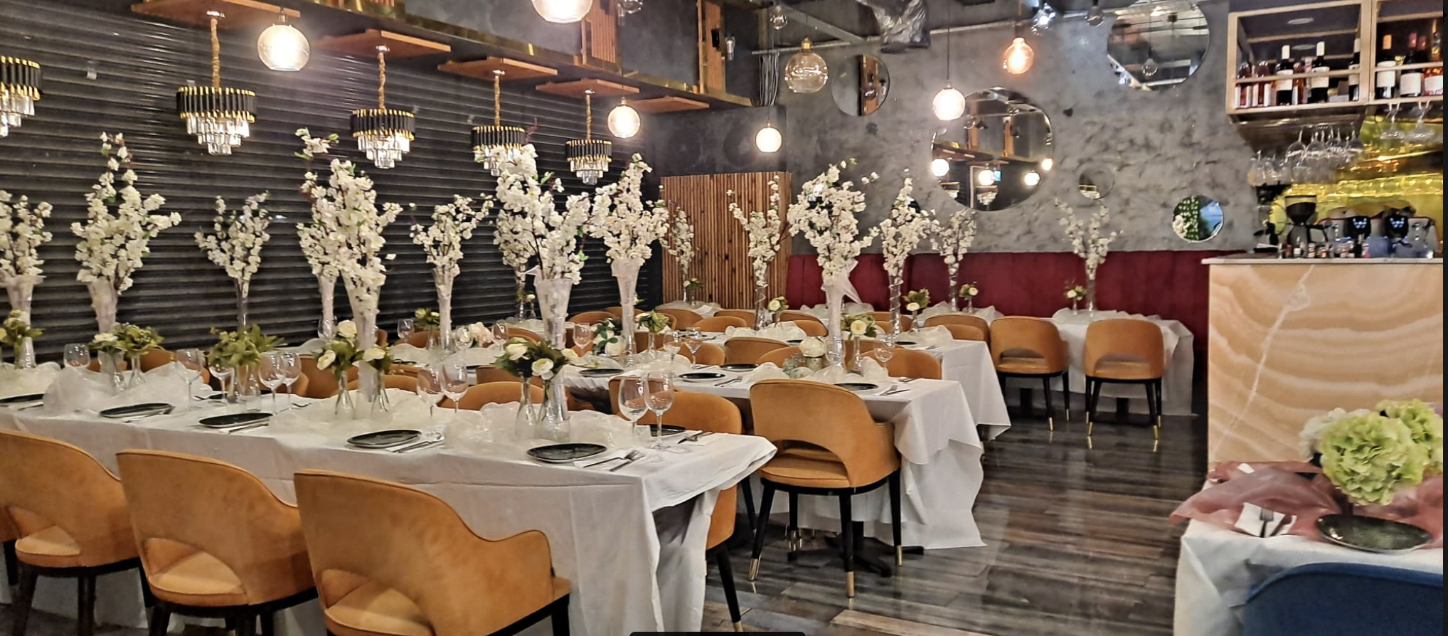 Elegant dining space with floral centerpieces for upscale corporate events.