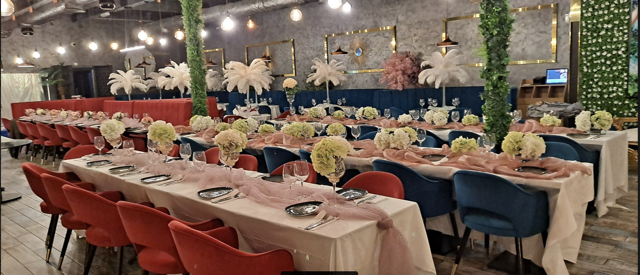 Elegant banquet hall with pink drapery and floral centerpieces for upscale events.