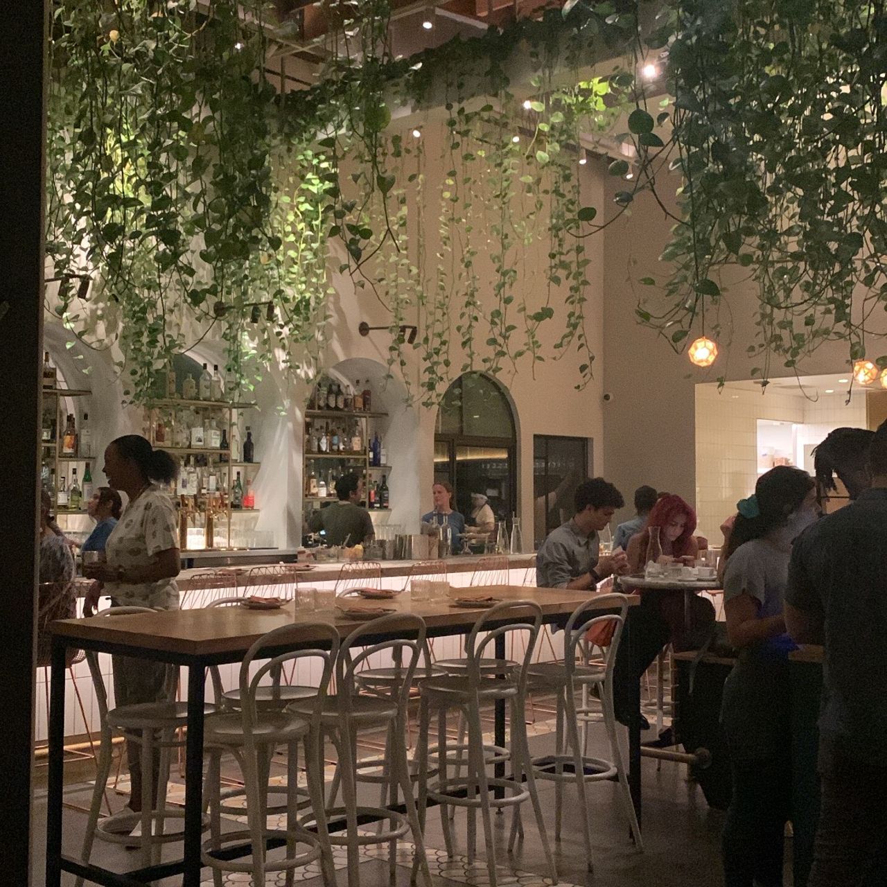 Vibrant Bavel Restaurant dining space with lush greenery for intimate gatherings and events.