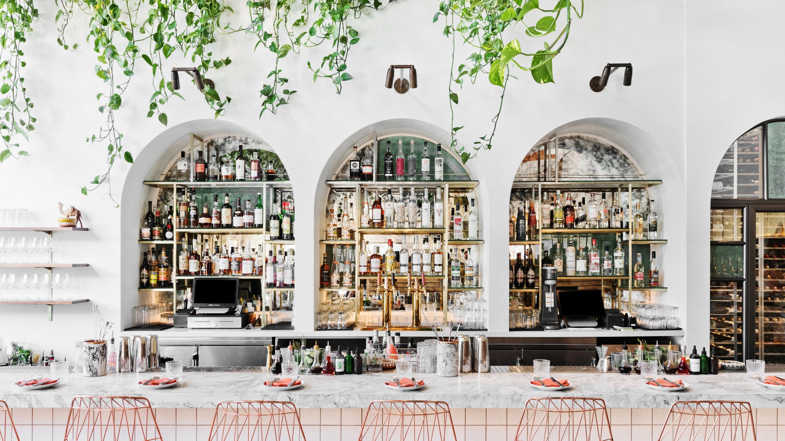 Stylish Bavel Restaurant bar with arched shelves, ideal for cocktail receptions and networking.