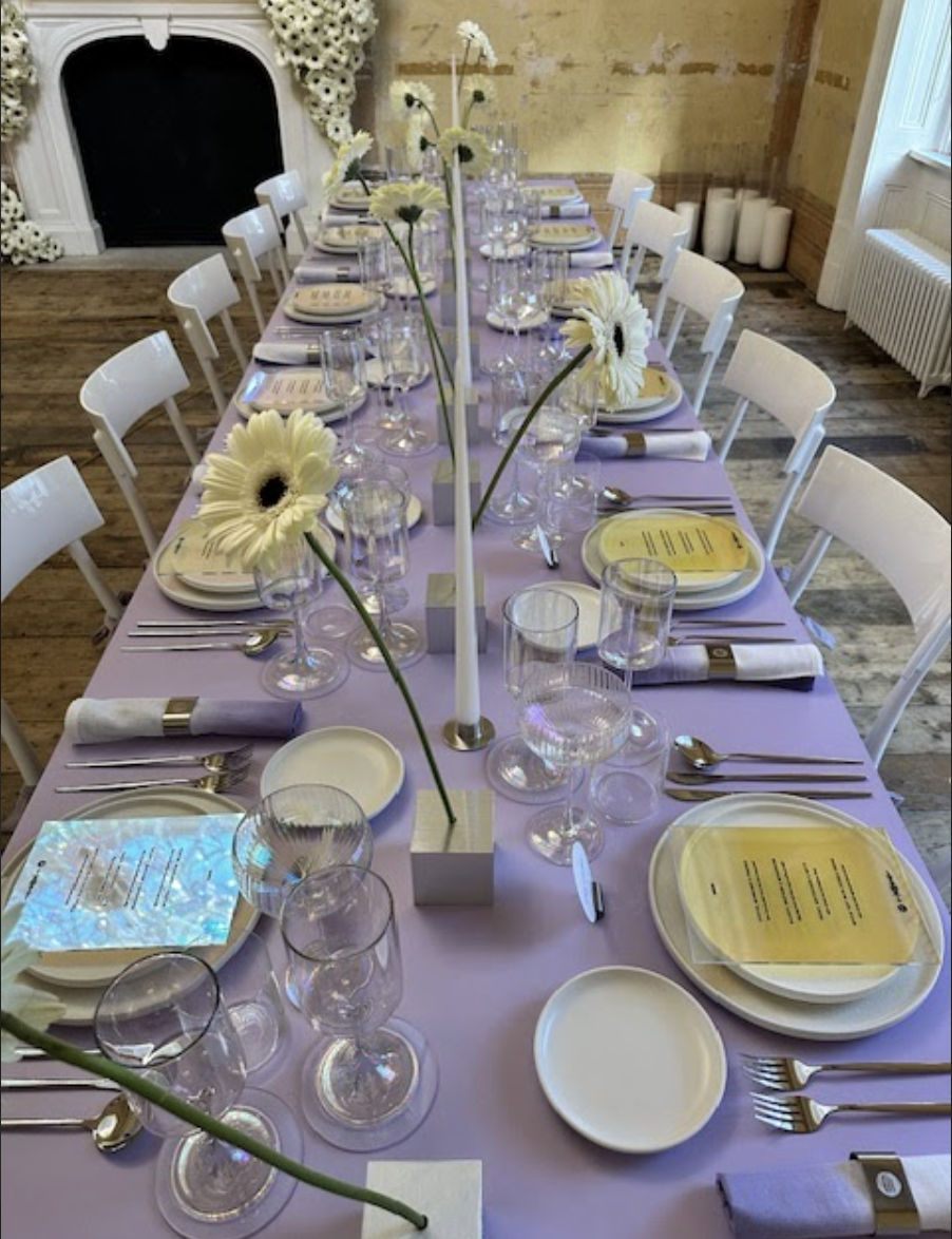 Elegant dining table setup with lavender cloth for networking event at Knotel Workclub.
