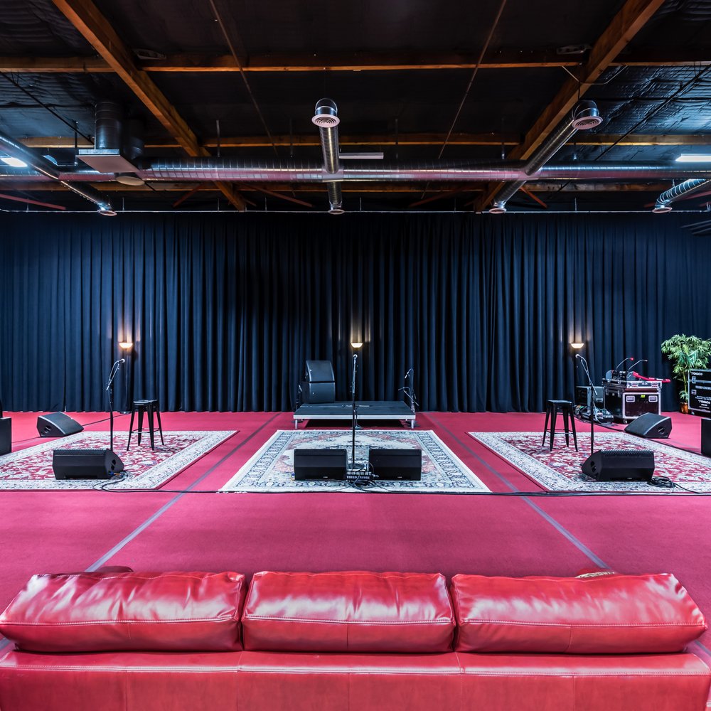 Large Rehearsal Room with black backdrop, ideal for live performances and events.