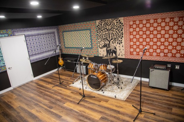 Large Rehearsal Room with stage, ideal for music events and creative gatherings.