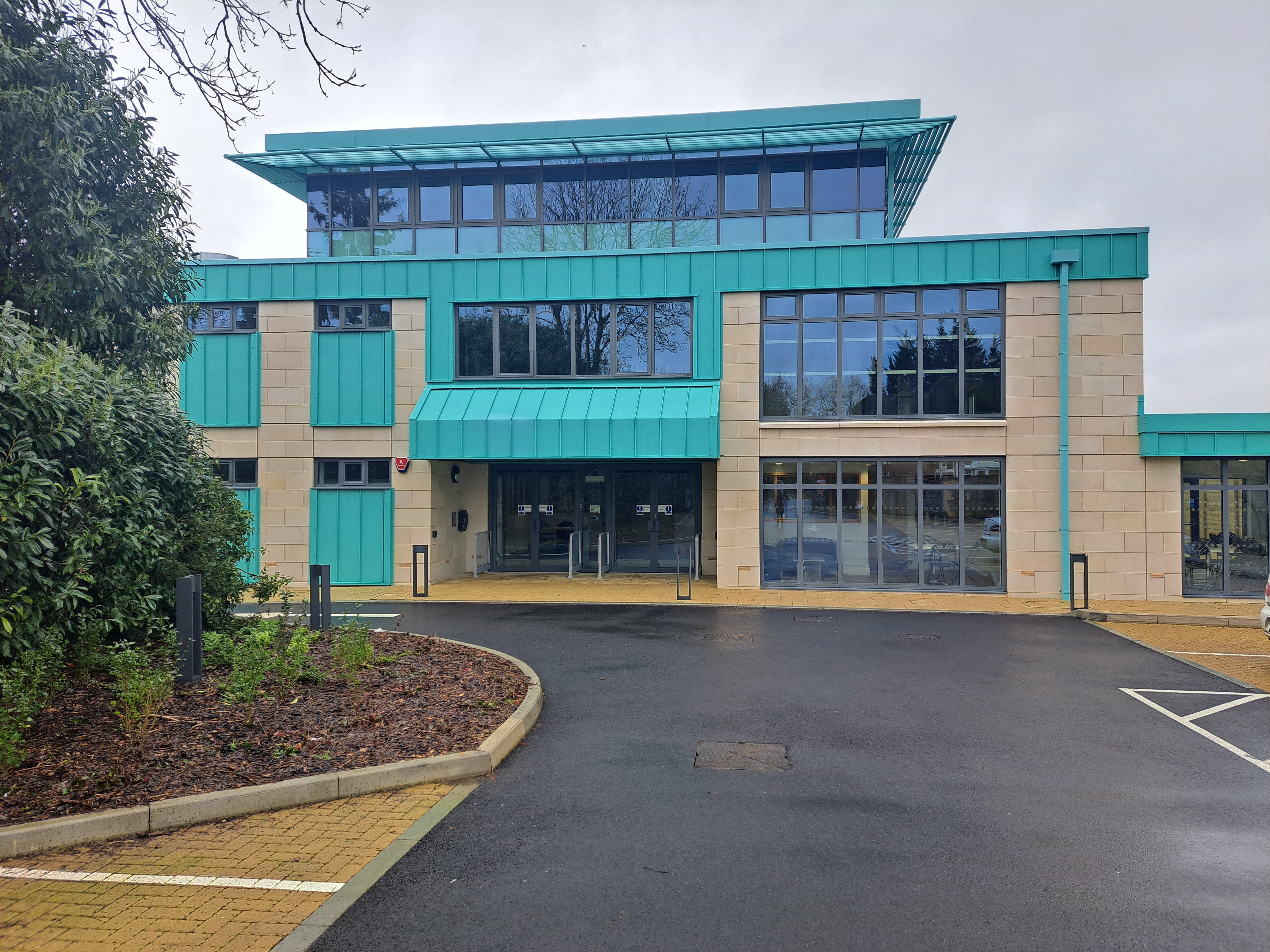 Modern turquoise conference venue with large windows for events and meetings.