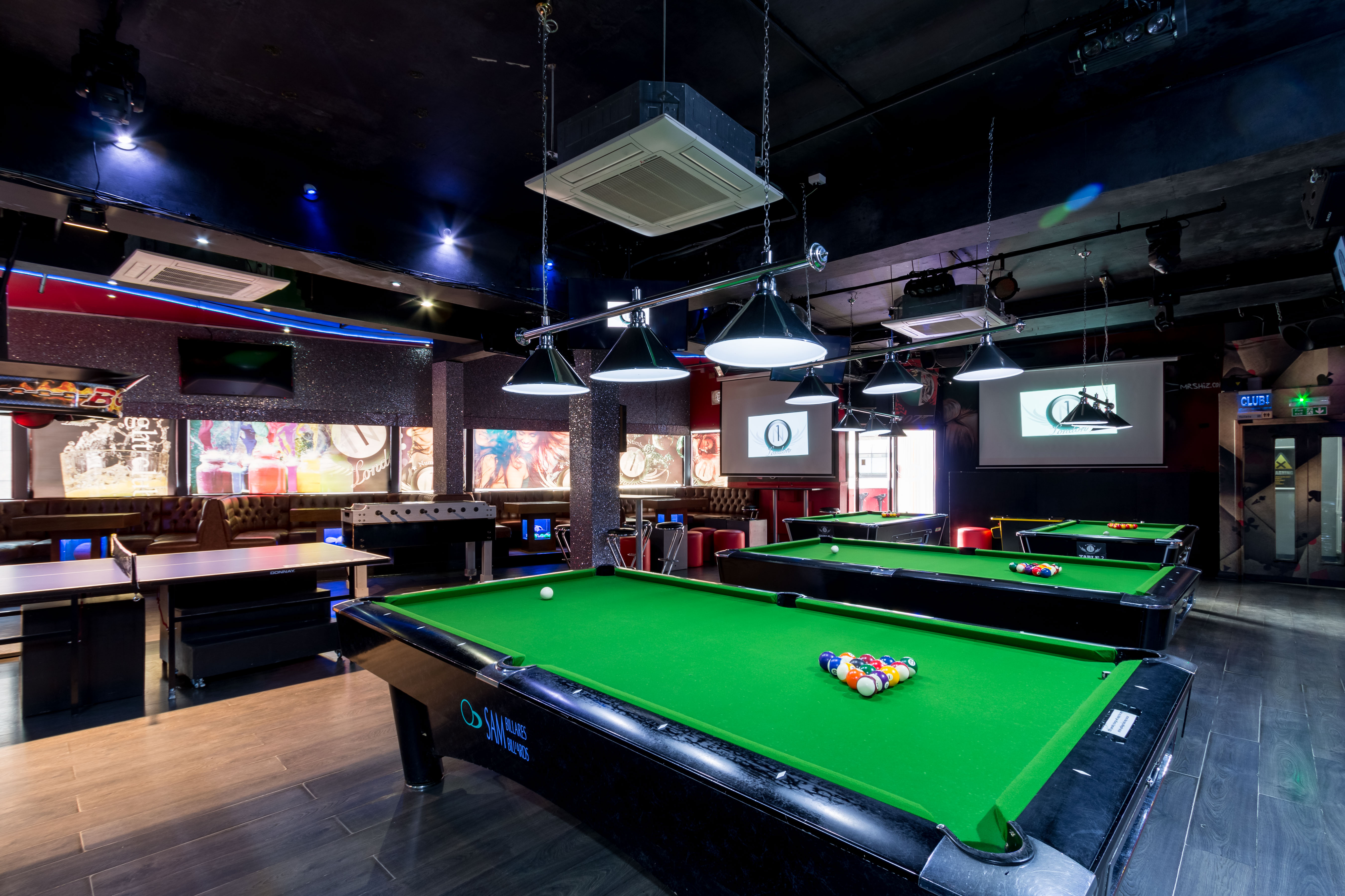 Vibrant event space with pool tables for networking and team-building activities.